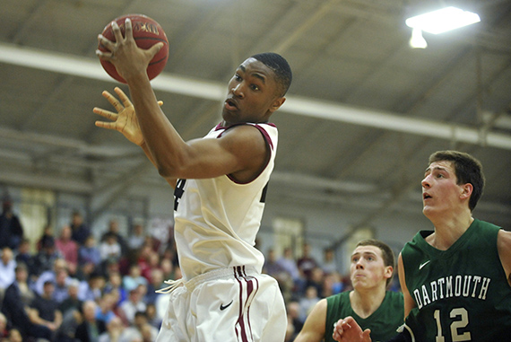 Crimson forward Zena Edosomwan '17 corrals a rebound in front of a couple of Dartmouth defenders. 