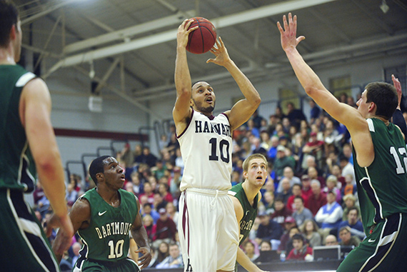 Crimson guard Brandyn Curry '14 gets off a jump shot despite being surrounded by Big Green defenders. Curry had a team-high 17 points, as well as six rebounds and six assists.