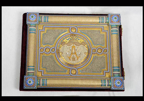 While early albums were quite plain, later covers became objects of art just as beautiful as the photographs they enclosed. This jewelrylike album cover from Alexander III’s collection is gilded and enameled.