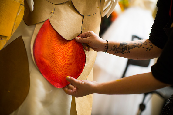 Jackie Olivia shows parts of a dress design in the crafts shop. 