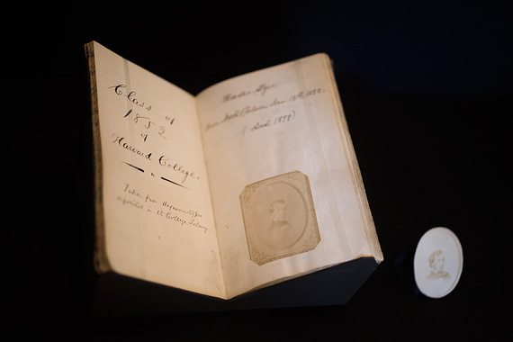 A detail image of a display case with the  album's title page and portrait of Horatio Alger, Class of 1852.