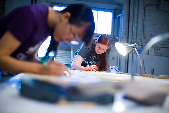 Rebecca Chen ’16 (left) and Elizabeth Hubbard ’18 repair a plaster cast of an ancient relief.