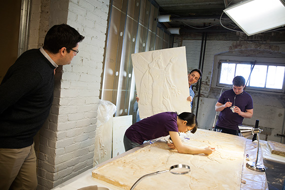 Gojko Barjamovic (from left) and Adam Aja discuss the details of the project while Rebecca Chen ’16 and Noah Wuerfel ’17 work to repair a plaster cast of an ancient relief. 