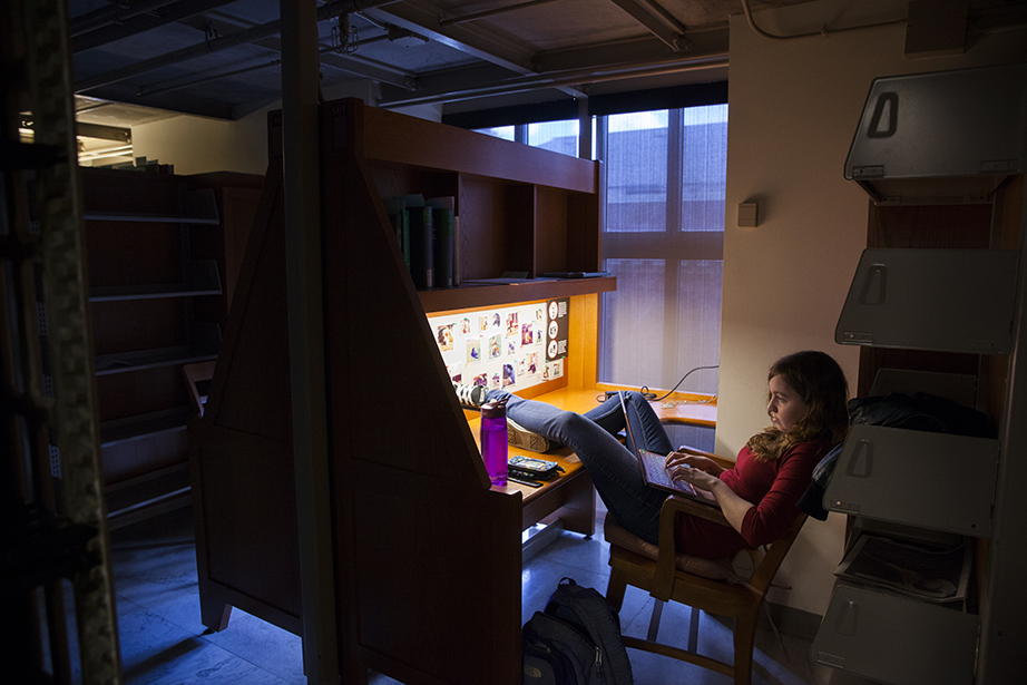 Louisa Kirk ’15 works at a carrel in Widener’s storied stacks.