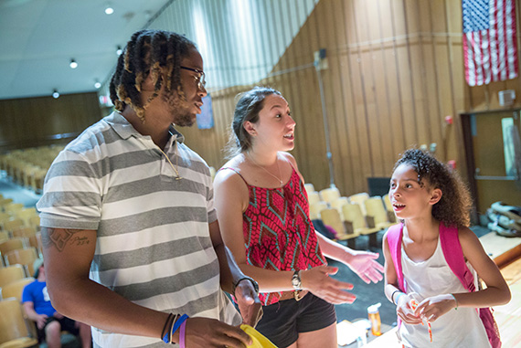 Javion Rookard (from left), CYEP director, and Sarah Gonzalez '18  work with Amaya Fifield, an Amigo School eighth-grader. 