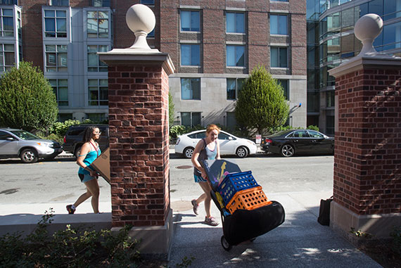 Zoe Onion '18 (right) and Rachel Gilchrist '18 take advantage of the beautiful day for moving crates.