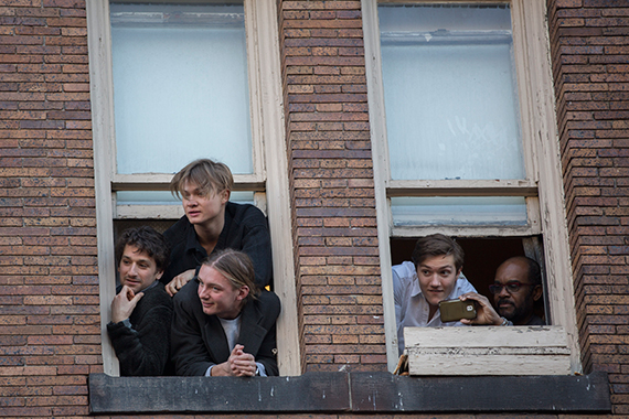 Rubbernecking members of Harvard's Finals Club watch the parade from their perch. Photo by Kris Snibbe/Harvard Staff Photographer