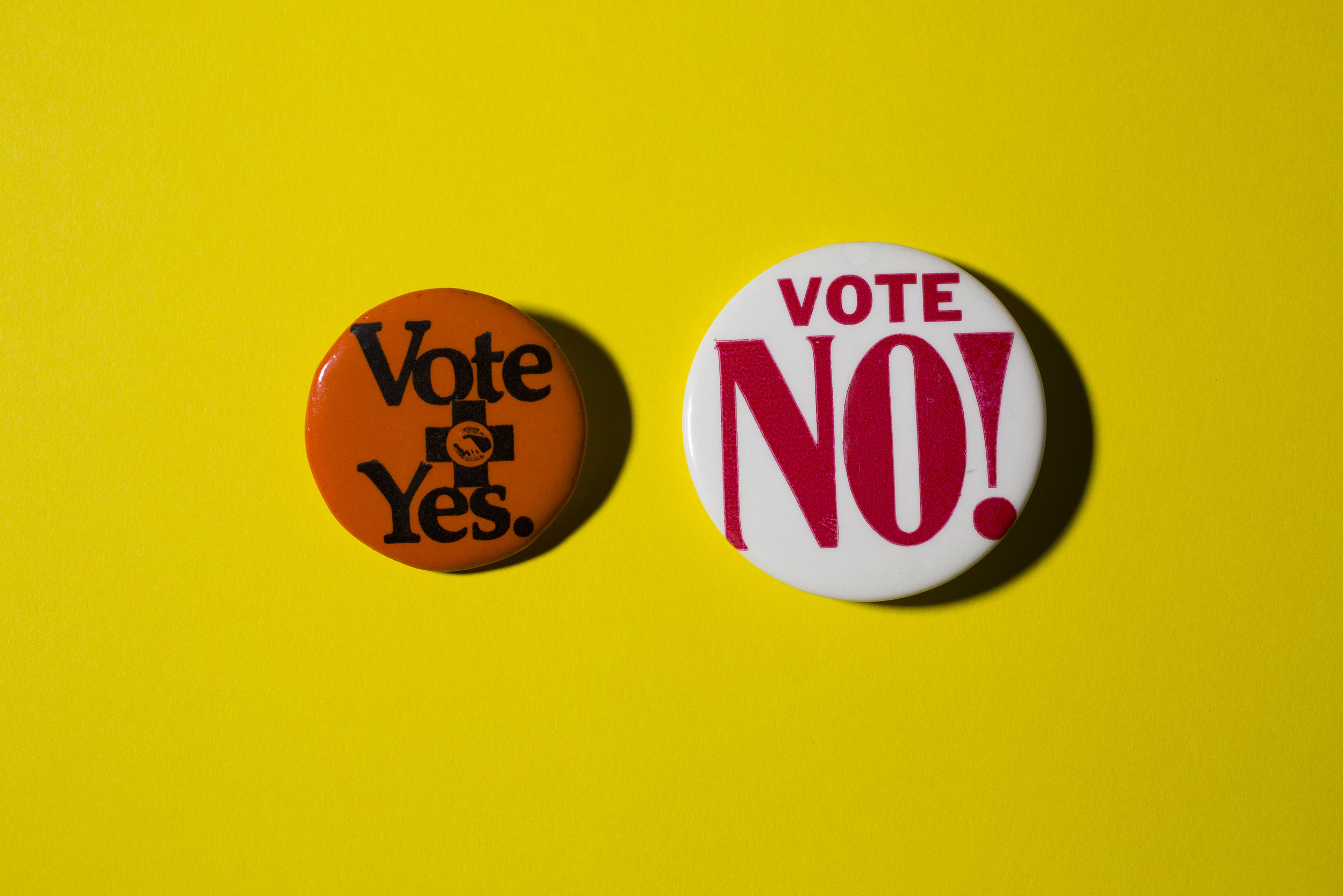 Buttons for and against ballot initiatives.