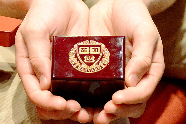Holding the box that his Harvard ring came in opened a flood of feelings for DeShaw. "The 'one ring' ceremony was a rare chance to see a representation of my time at Harvard," he said. Photo by Barbara DeShaw