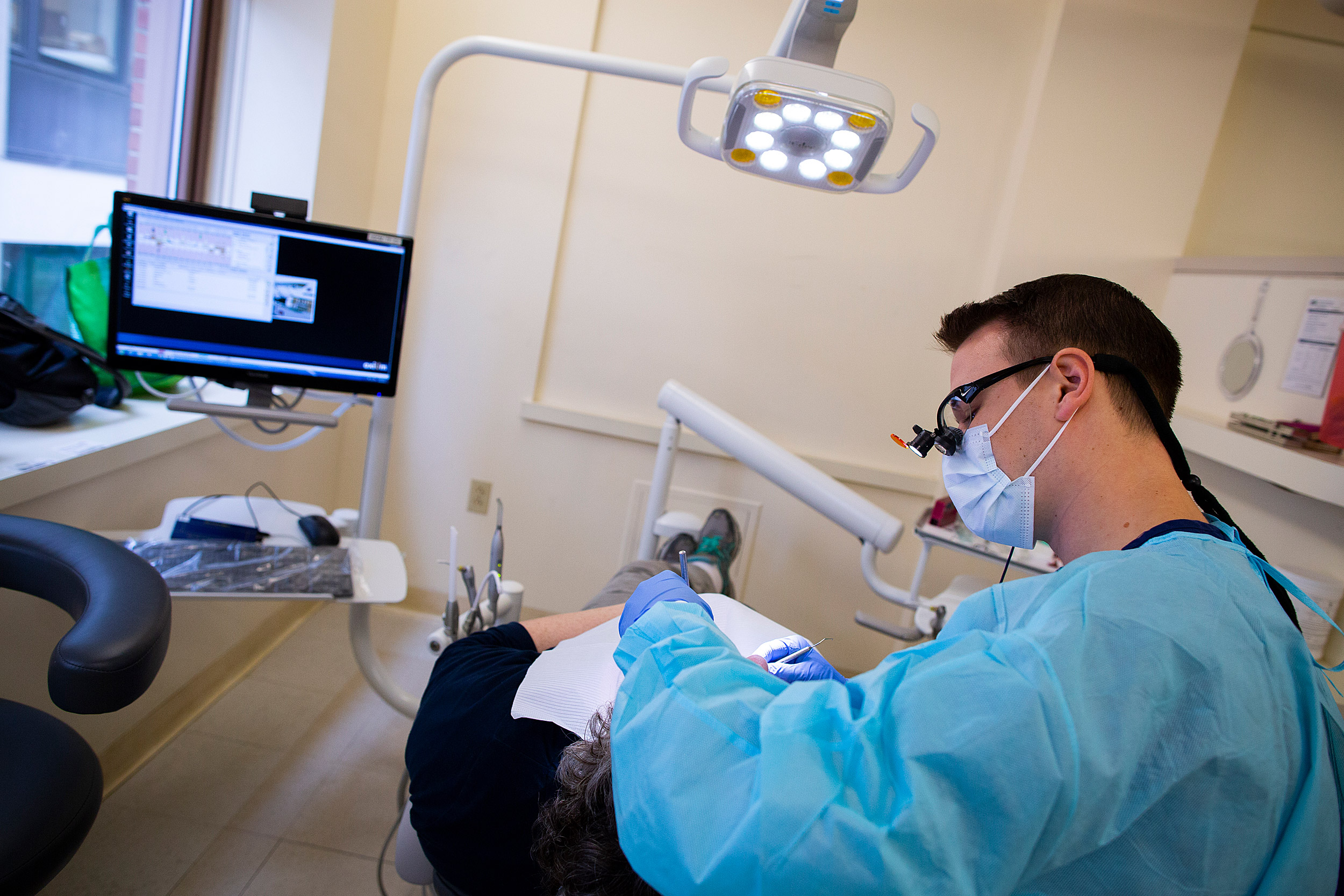 Tom Ferlito treats a patient at Harvard Dental Center.