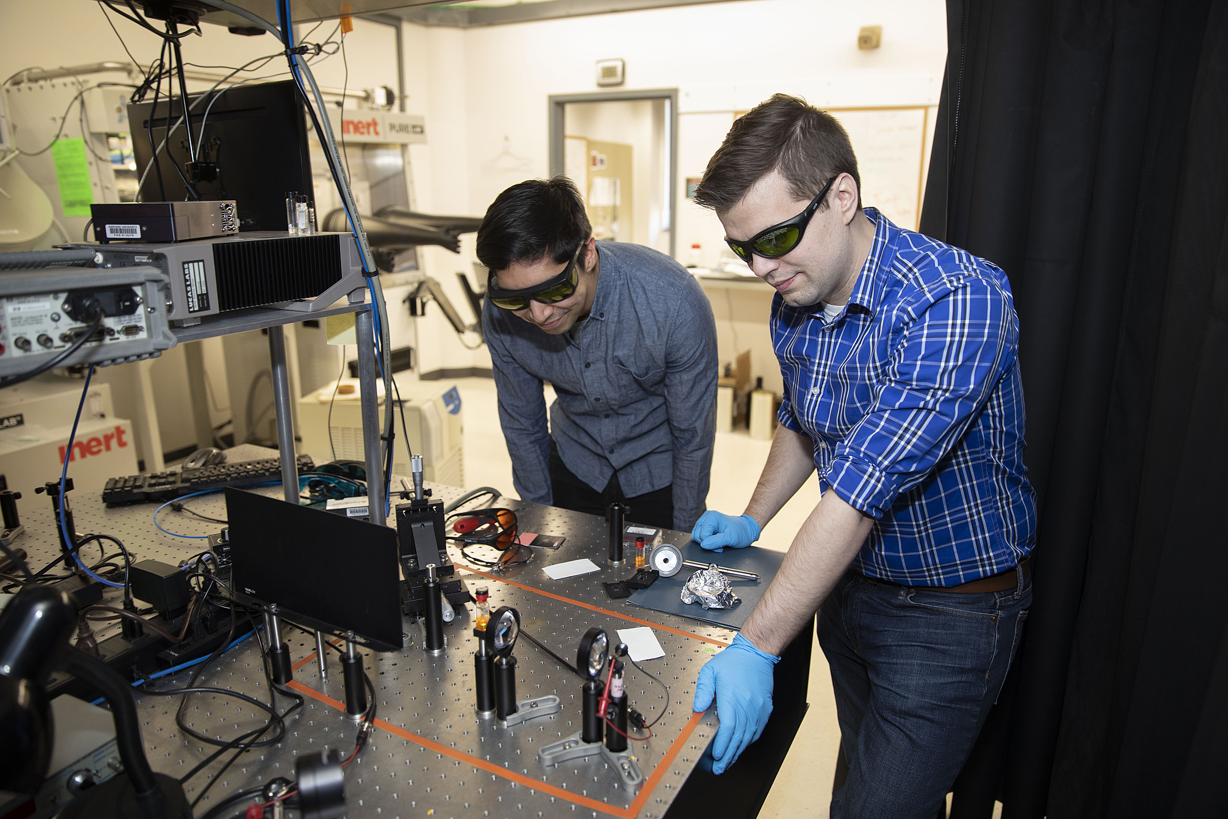 Dan Congreve and Andrew Pun work in the lab.