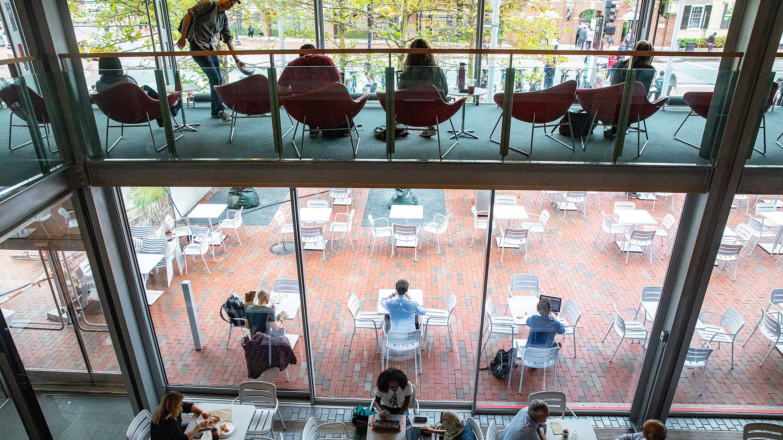 People sitting in front of the glass walls of Smith Center.