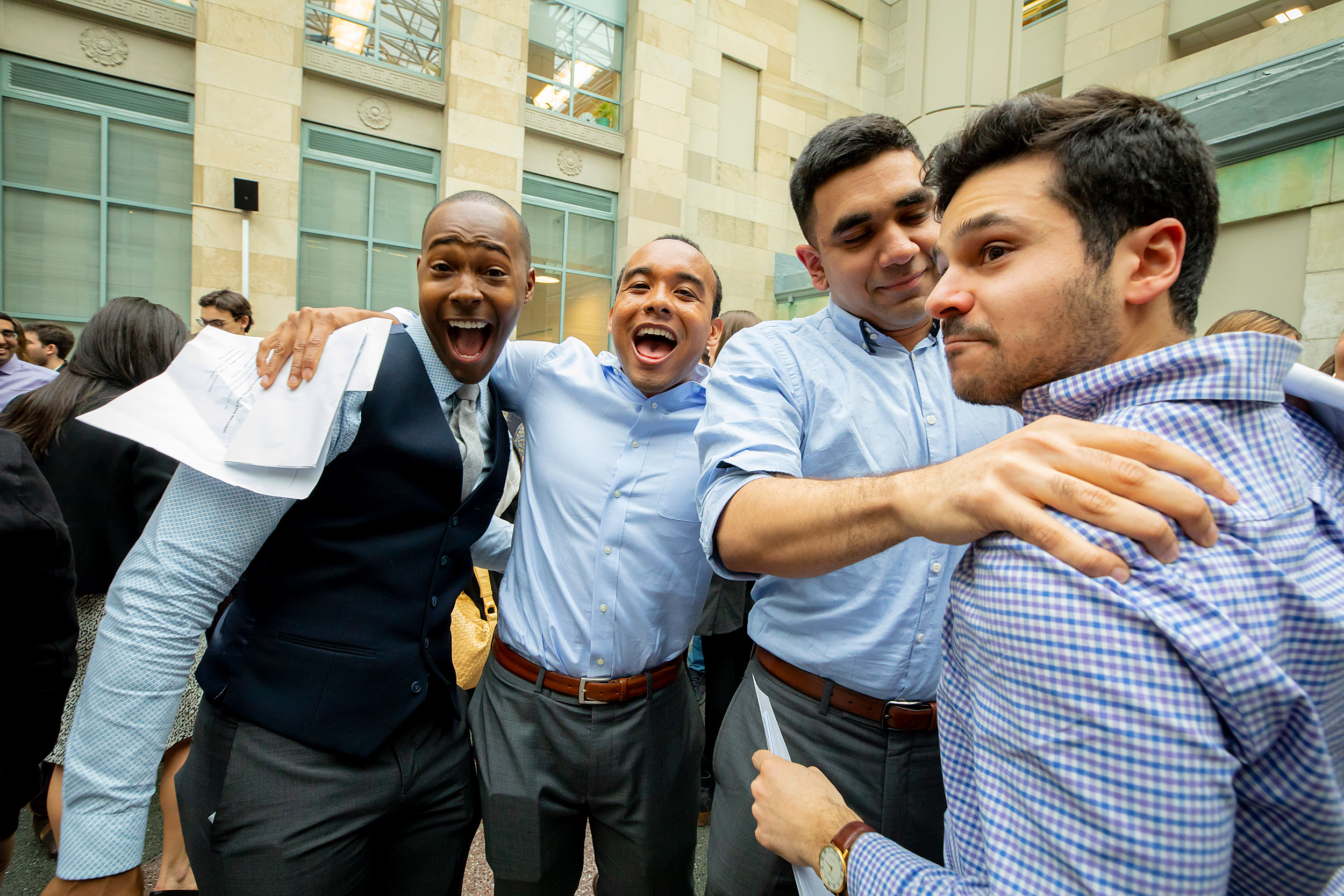 Danial Ceasar, from left, Leangelo Hall, Mubeen Shakir and Michael Chilazi congratulate each other.