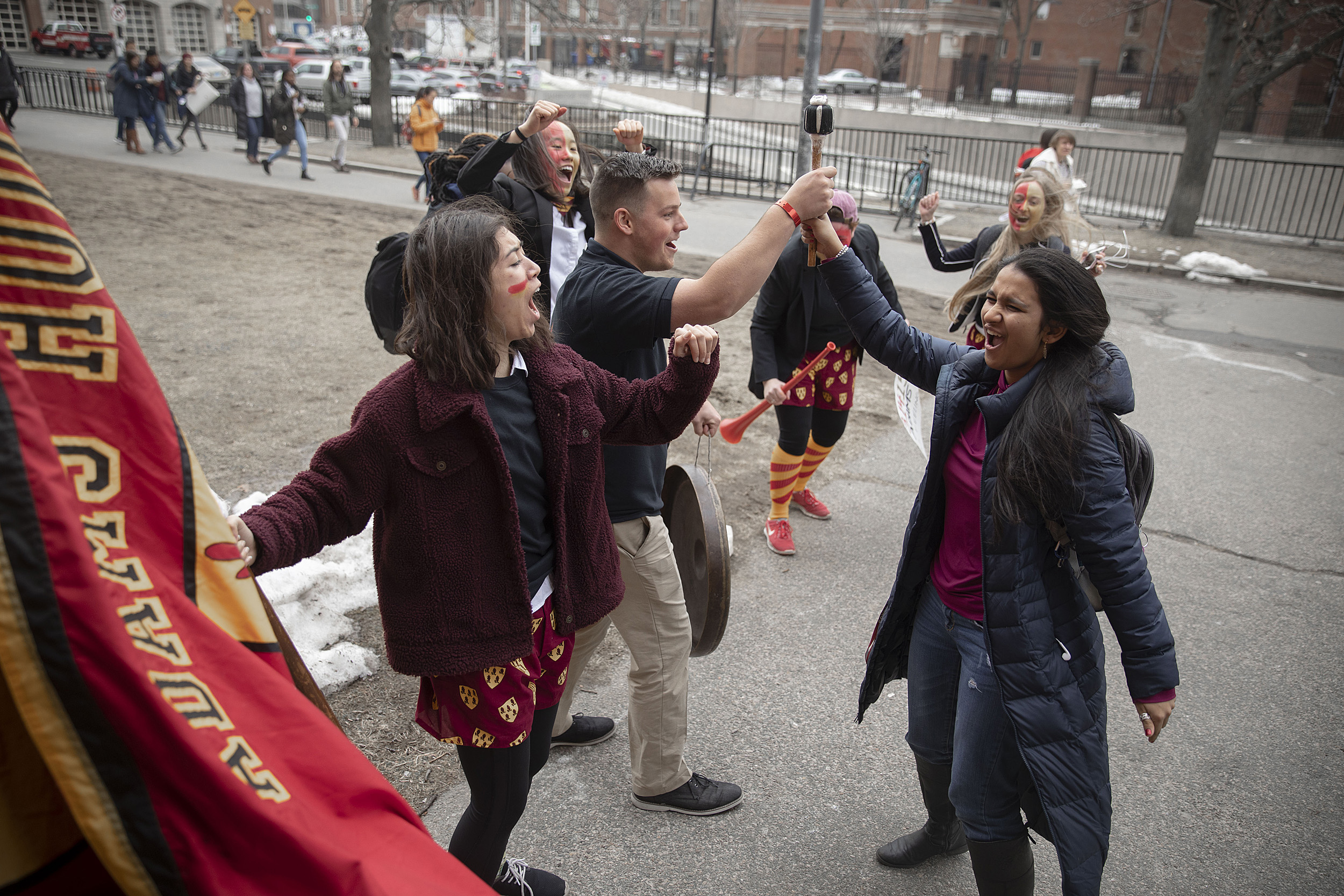 Students cheering and holding flags