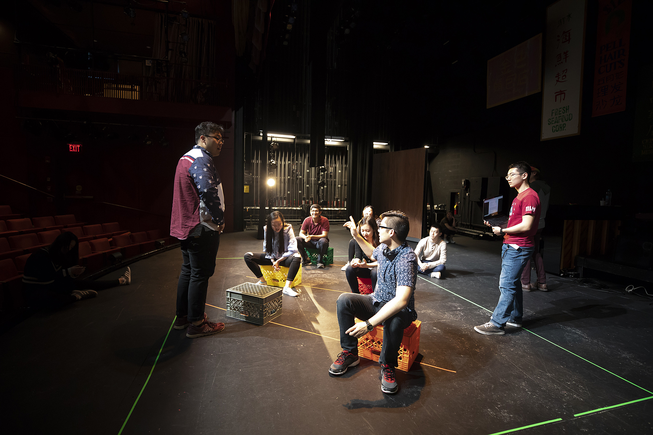 Performers sitting and talking on a stage