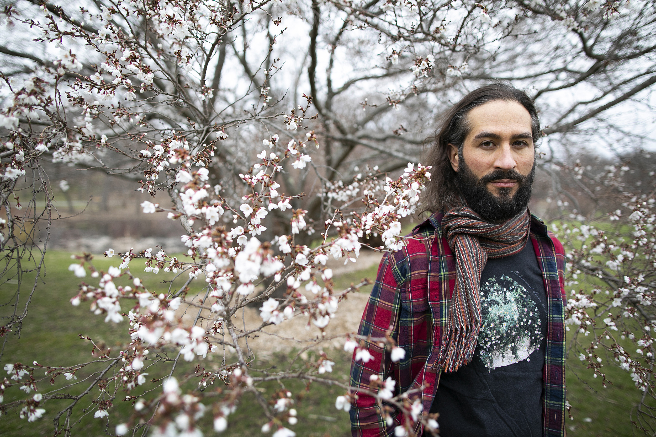 Samimi standing near a tree