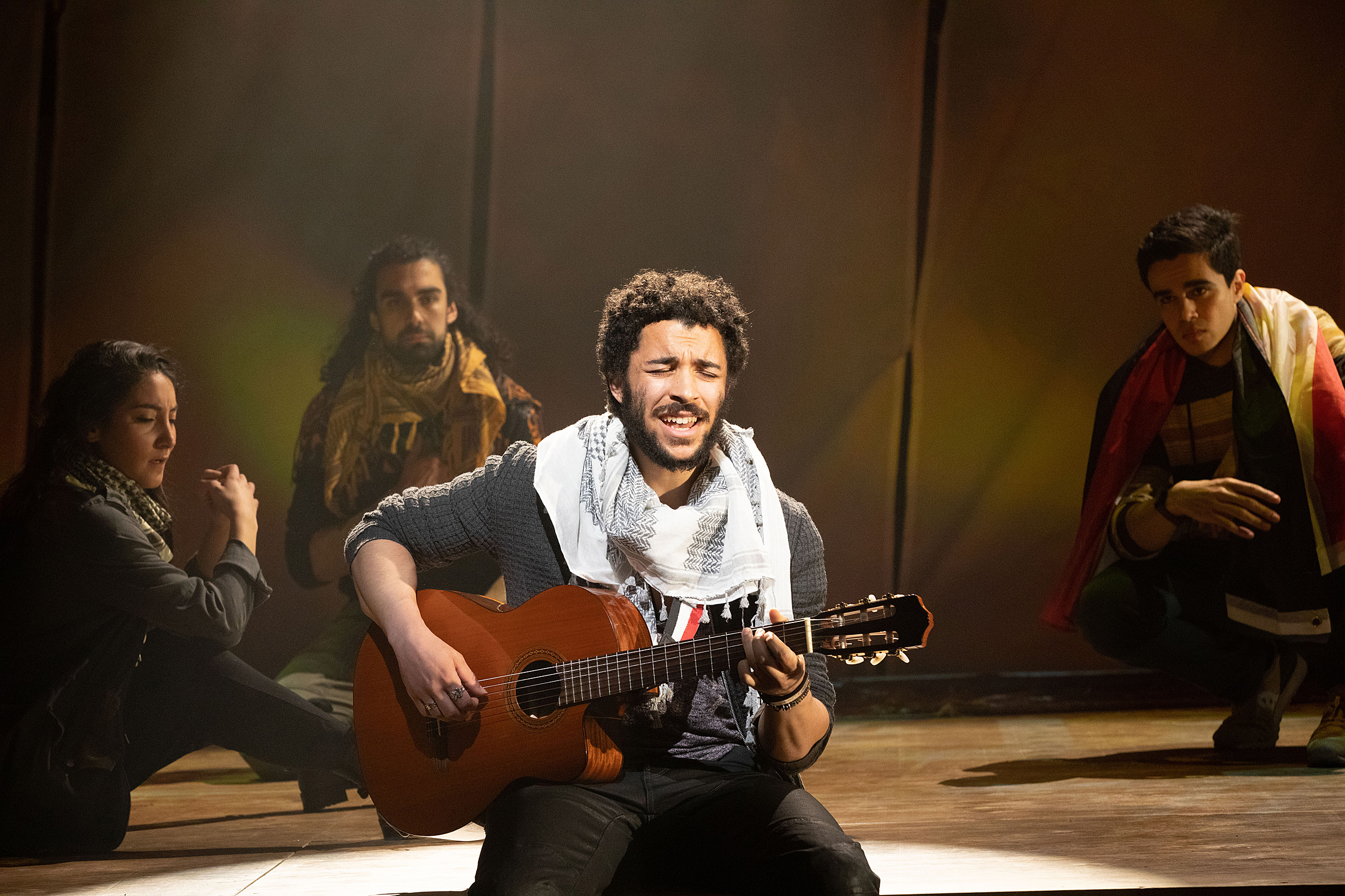 man singing and playing guitar