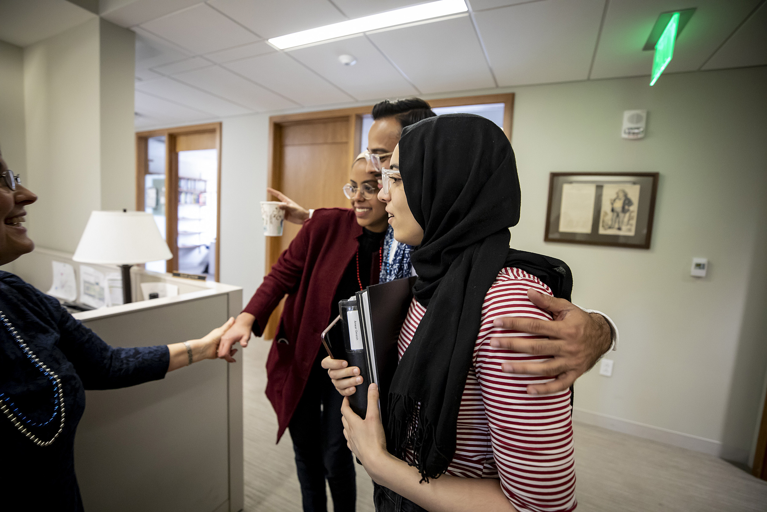 Anya Bassett, Senior Lecturer in Social Studies, Director of Studies, on left, accepts thesis' from Layla Siddig, Rohan Shah and Anwar Omeish