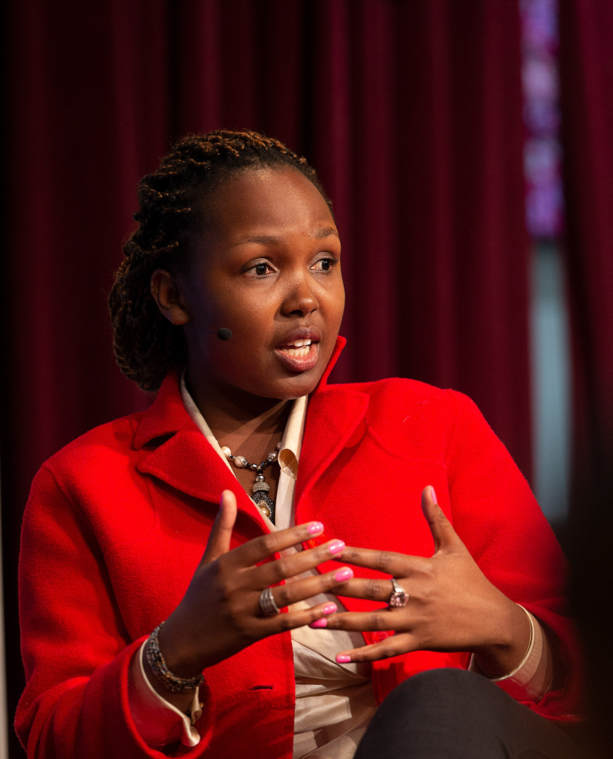 woman in red blazer speaking