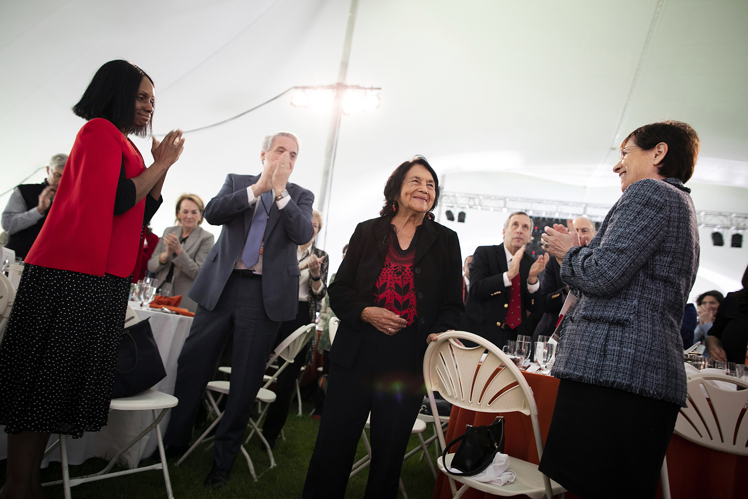 Dolores Huerta (center) is given a standing ovation from the audience.