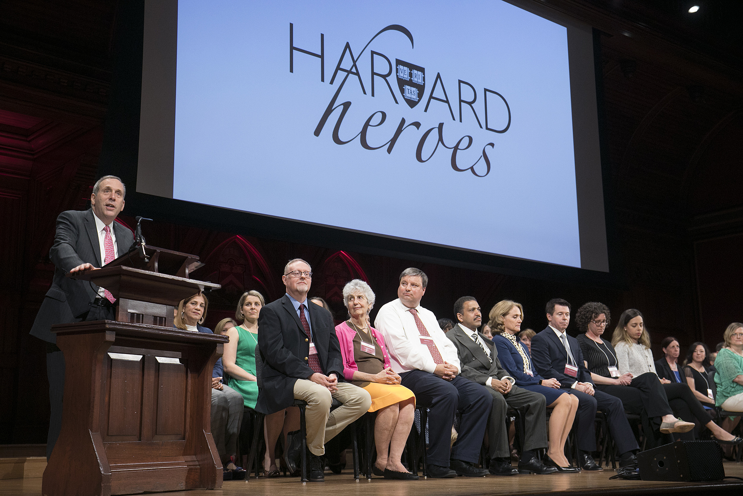 Larry Bacow at the podium onstage in Sanders Theater.
