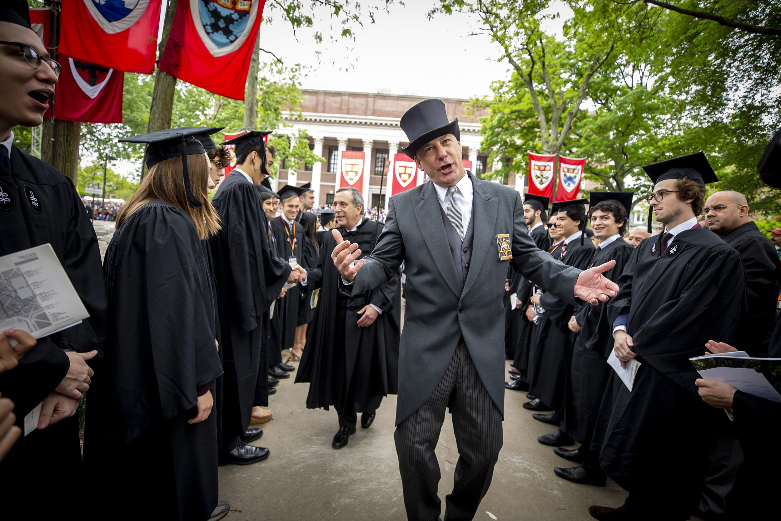 Peter Koutoujian walks ahead of Larry Bacow in procession.