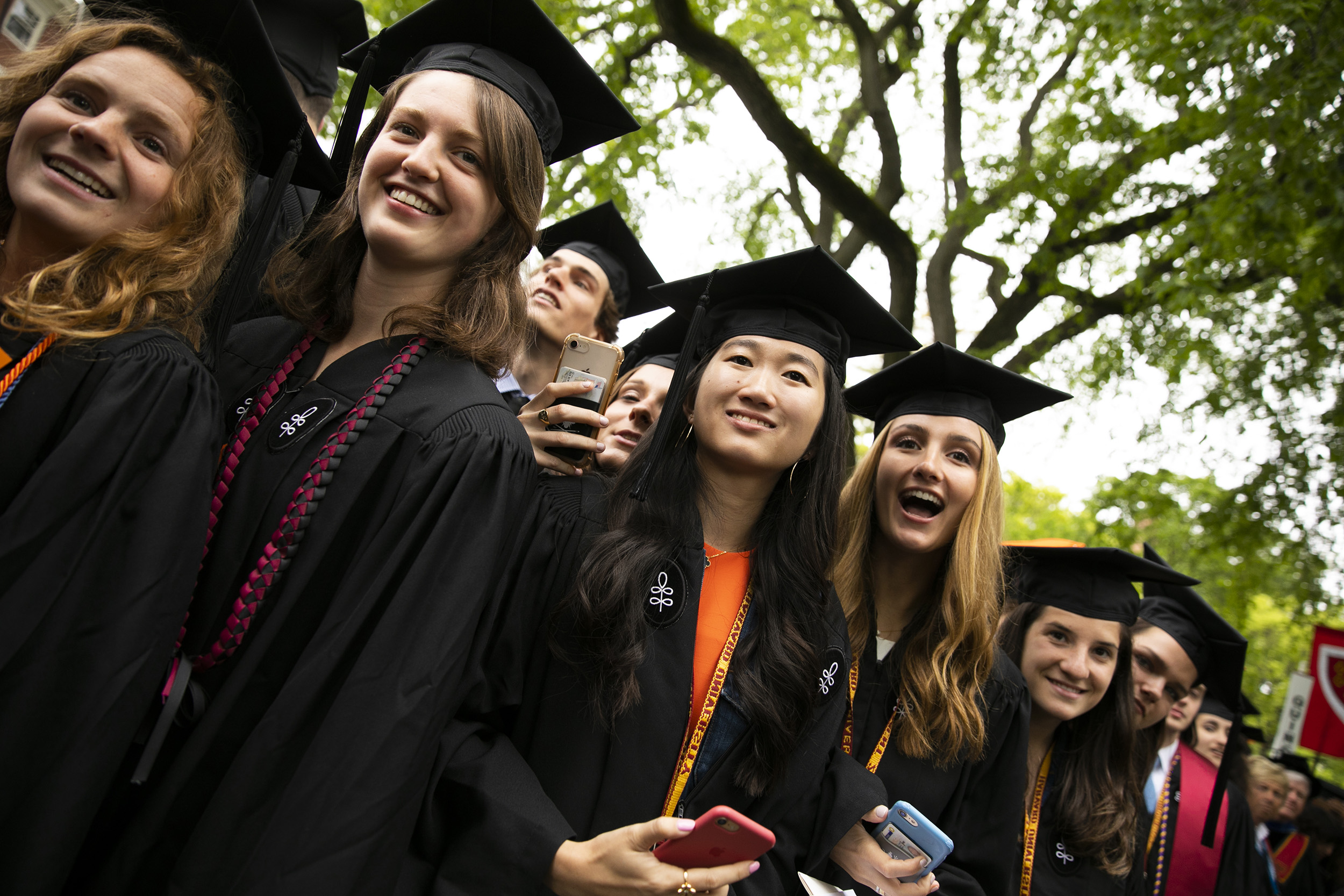 Graduates look excited as they spot Angela Merkel.