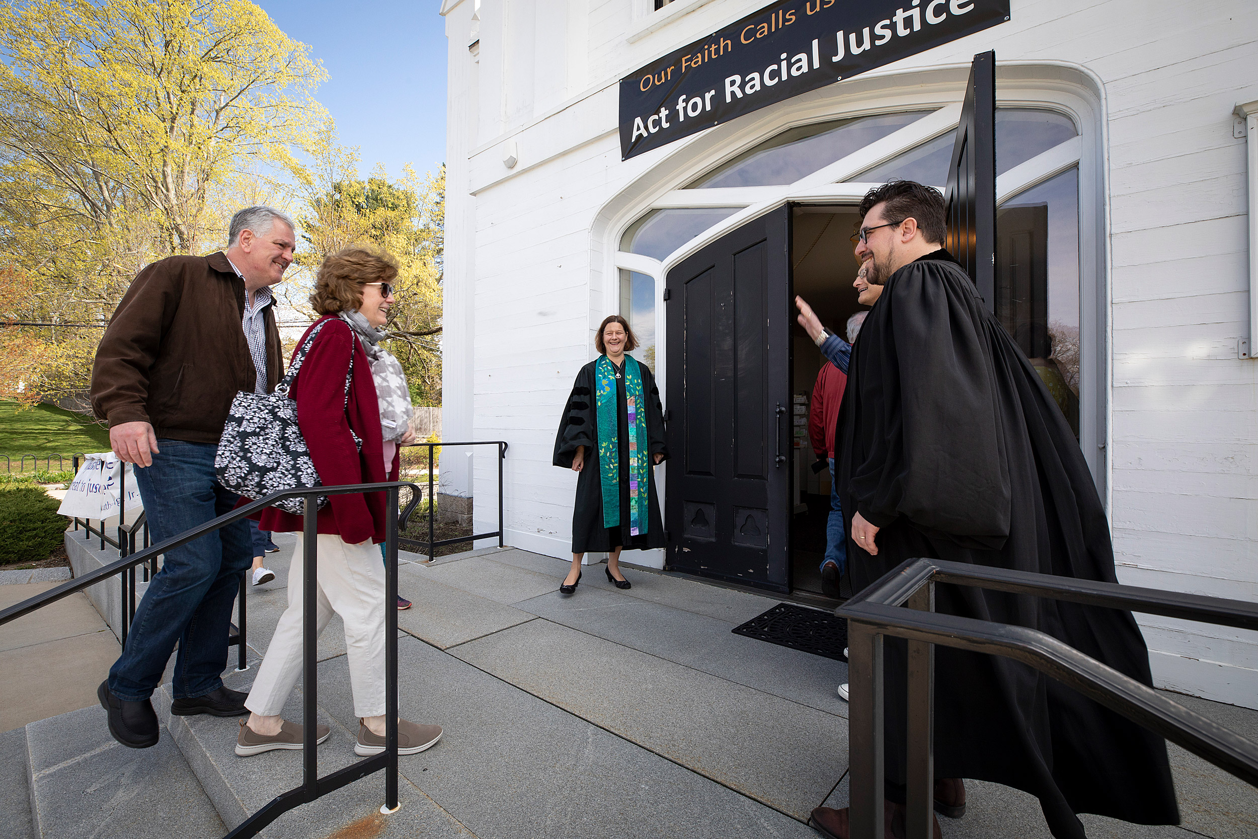 Israel Buffardi greets congregants entering church.