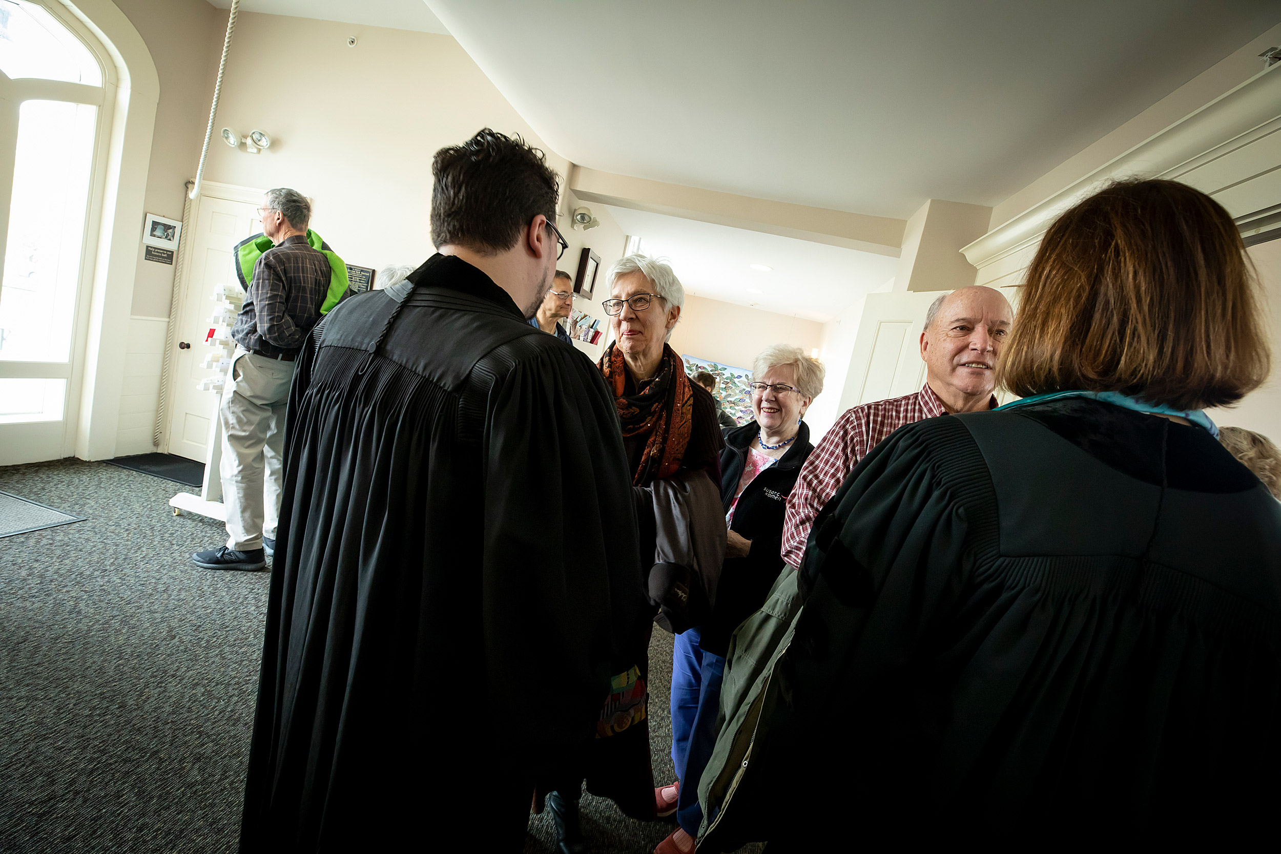 Israel Buffardi speaks with parishioners after the service.