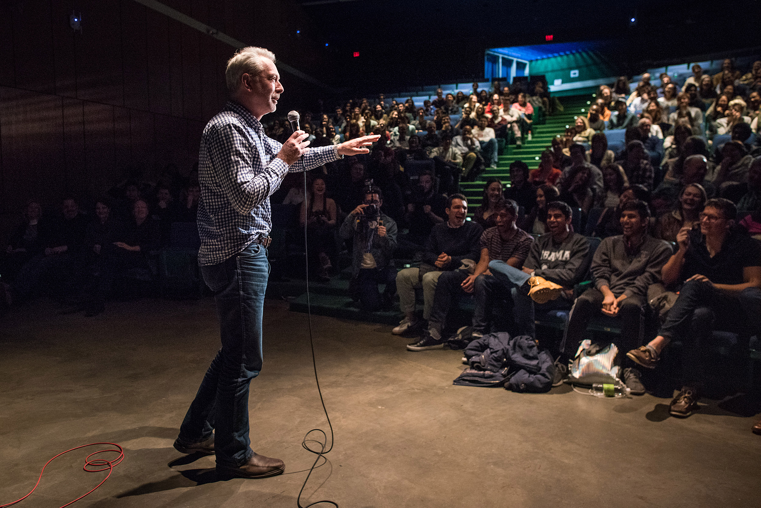 Andrew Berry on stage with mic.