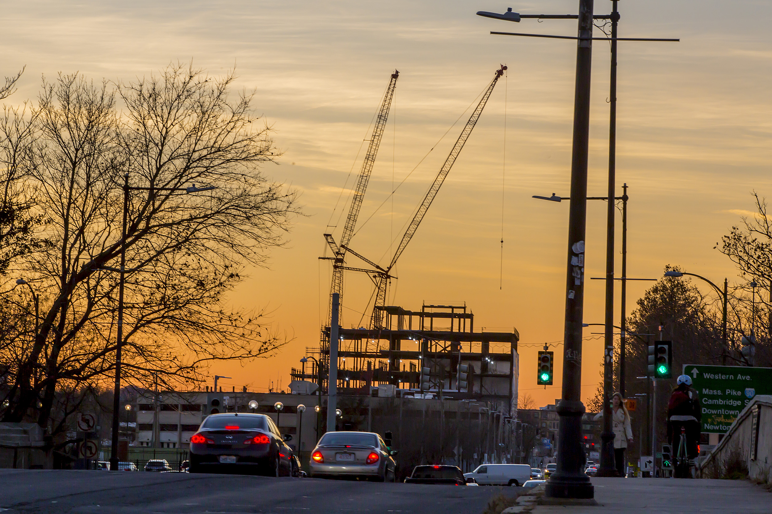 Building under construction in front of a sunset