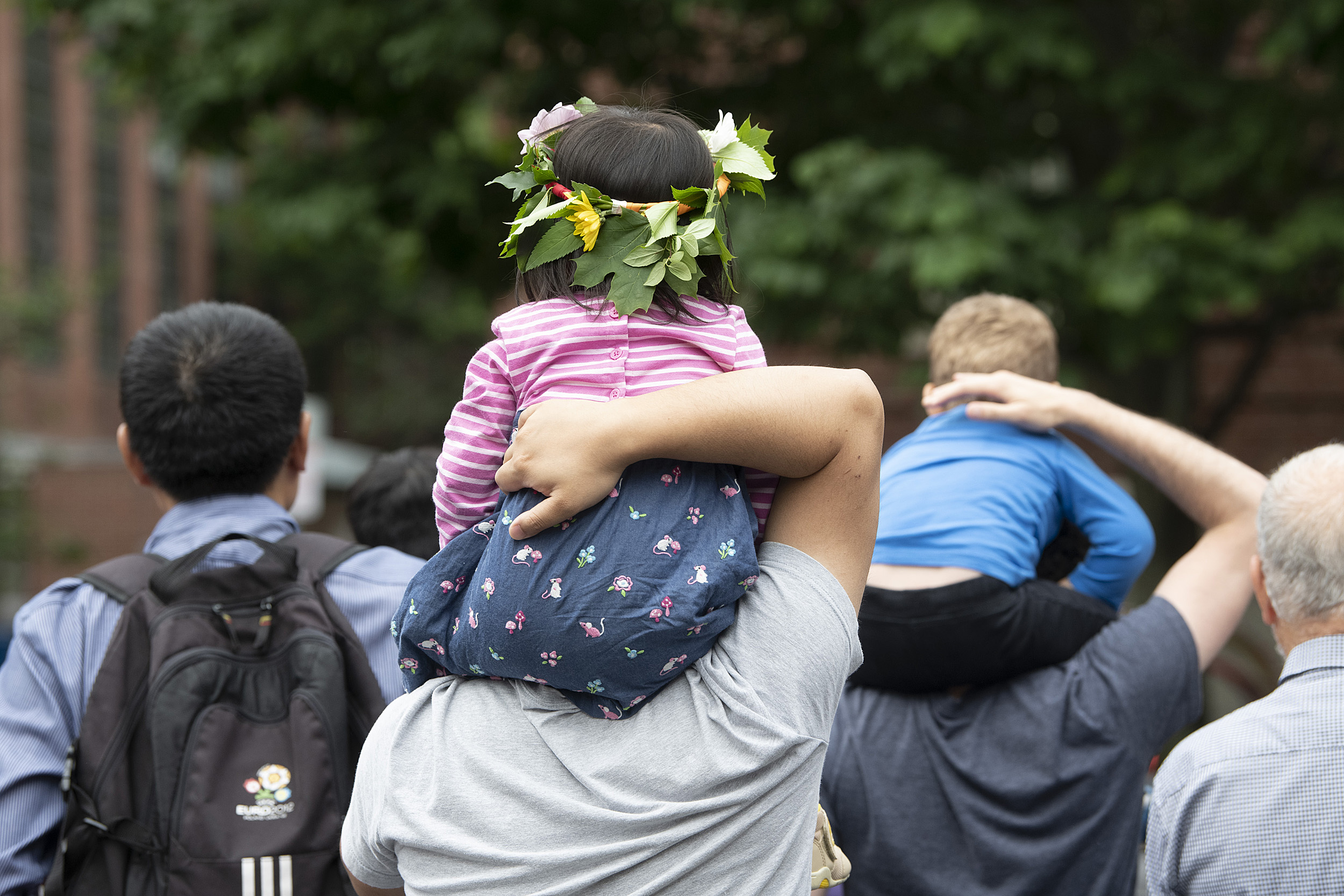 Child on parent's shoulders