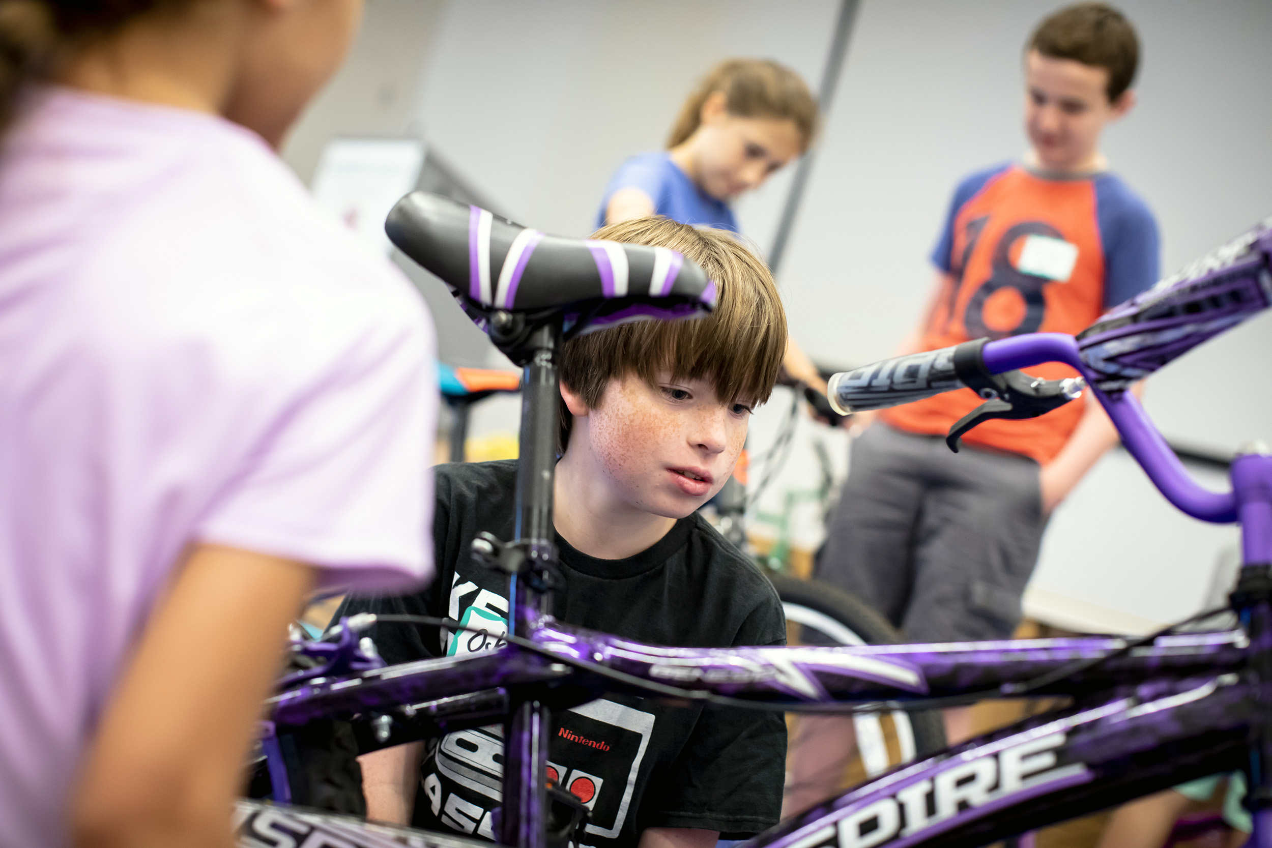 Oskar Monahan repairs a bicycle.