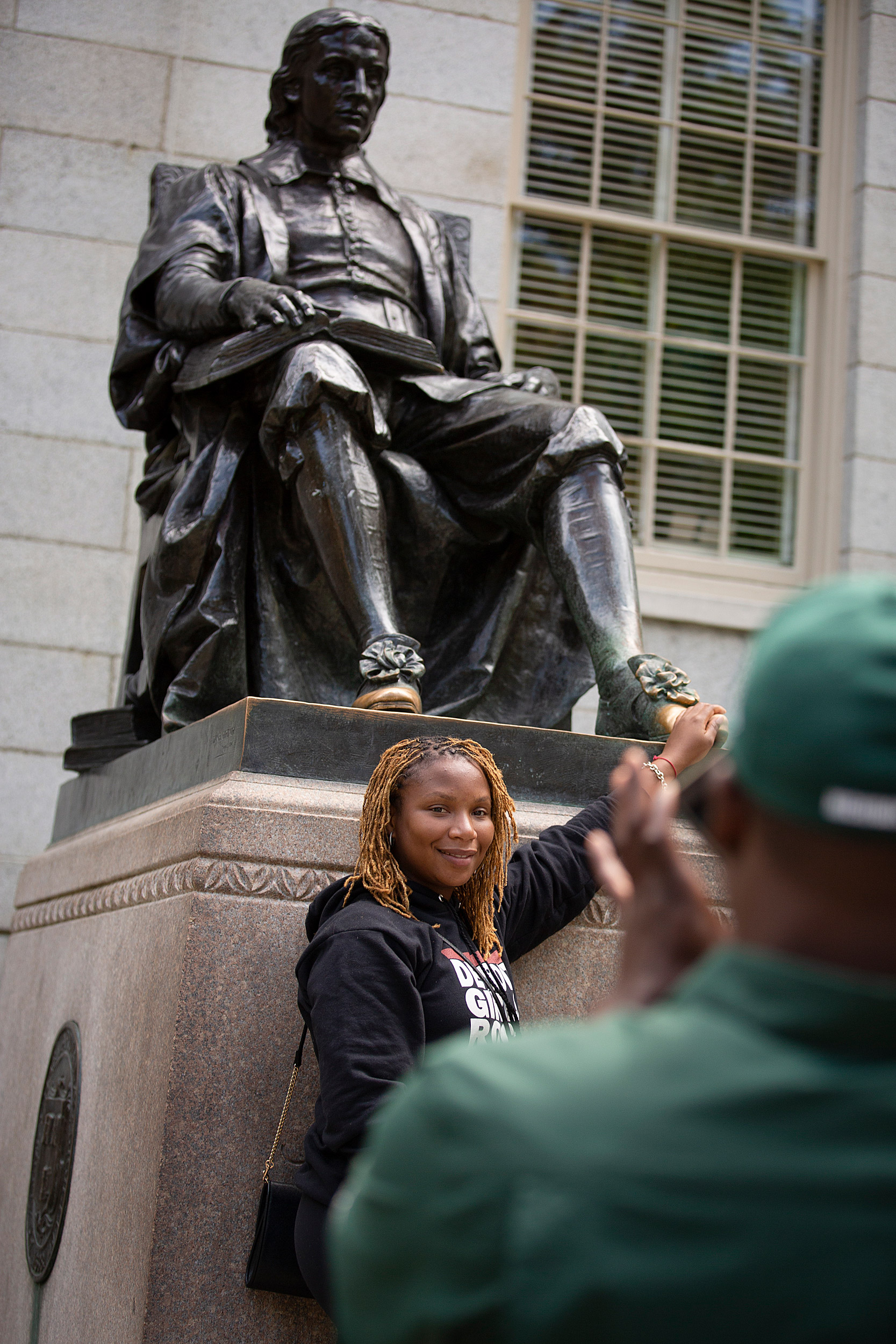 Tia Jackson touches the foot of the sculpture.