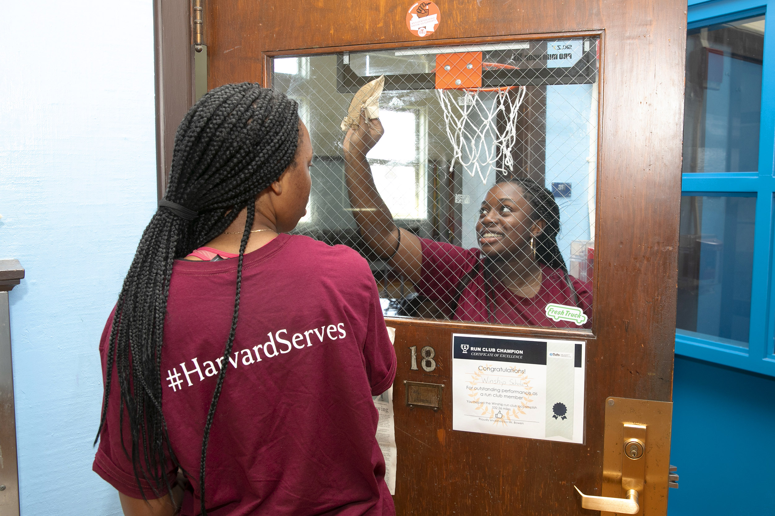 Students cleaning a window