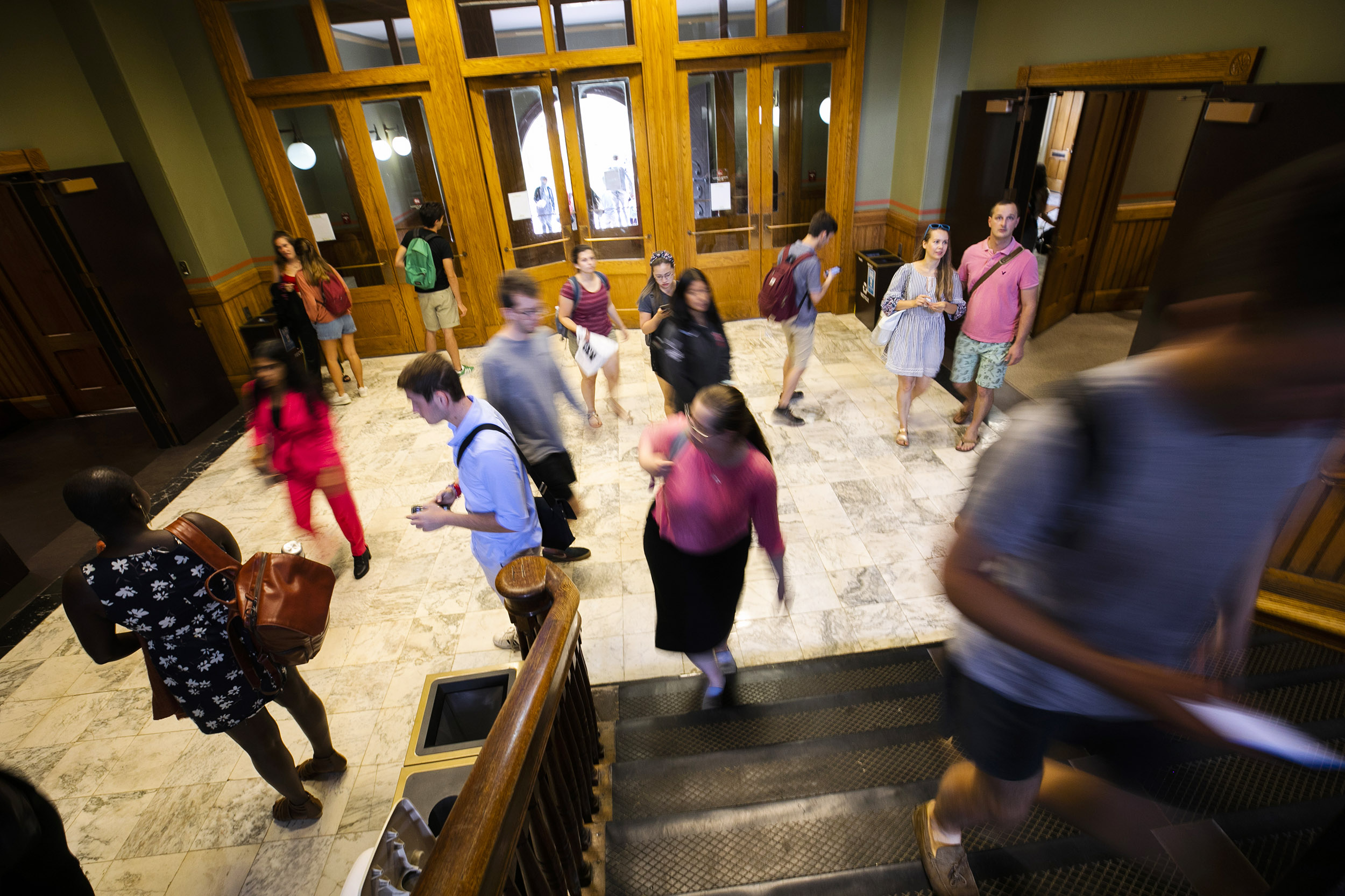 Students walk around the entrance to Sever Hall.