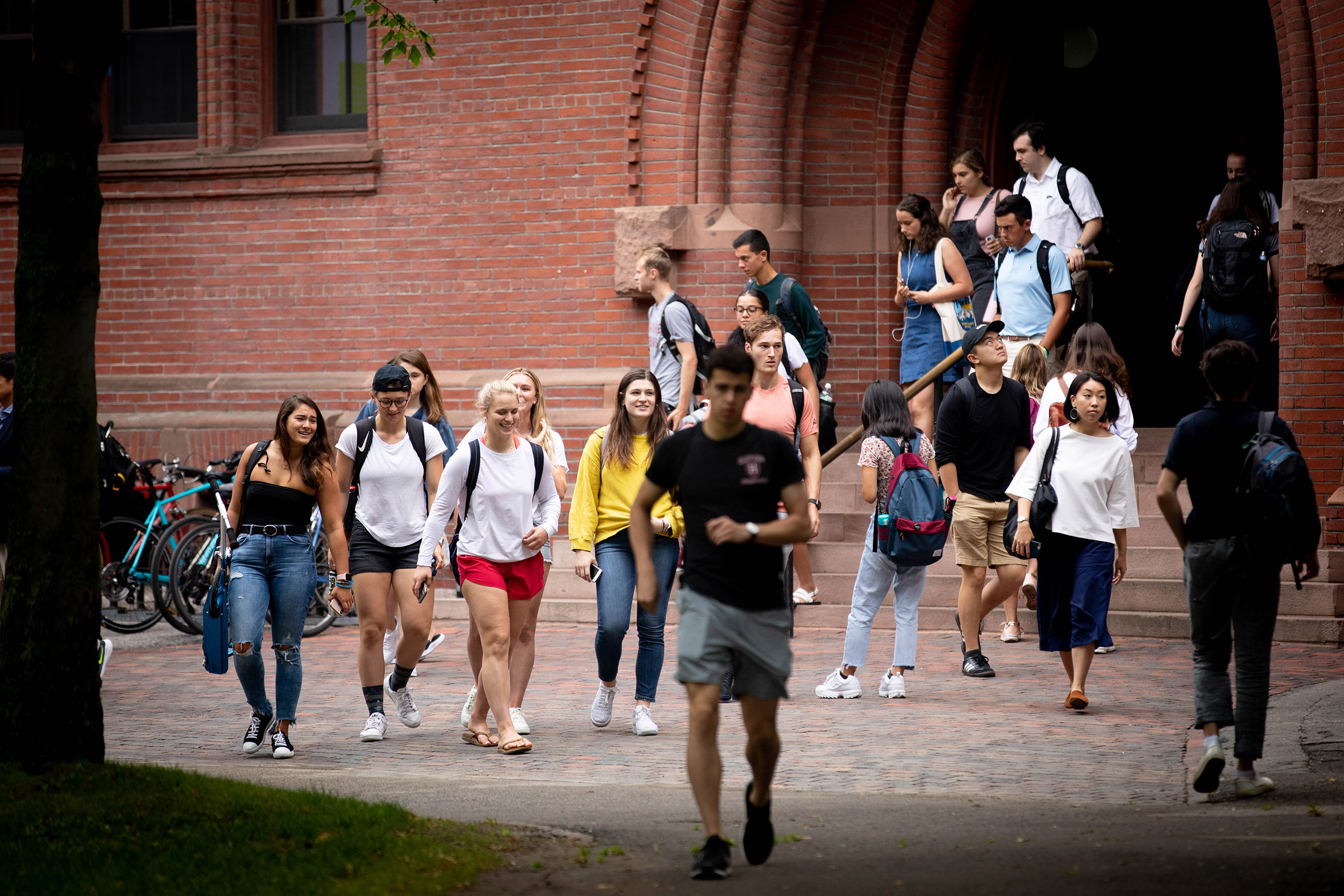 Students walk out of Sever Hall.