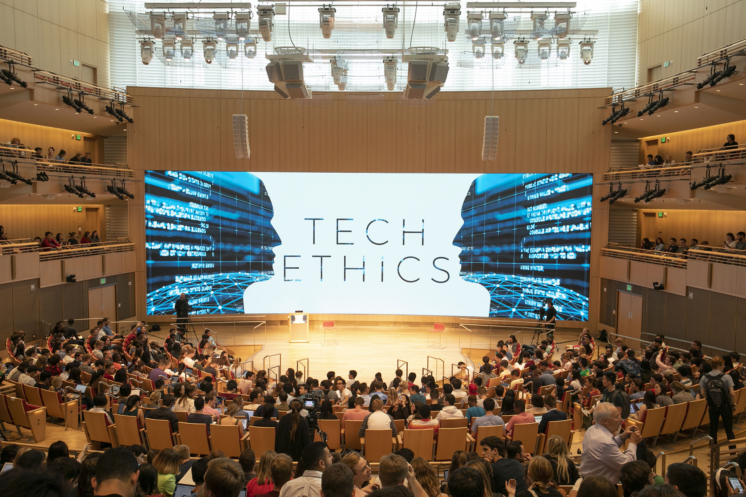 A crowded classroom with Tech Ethics on screen.