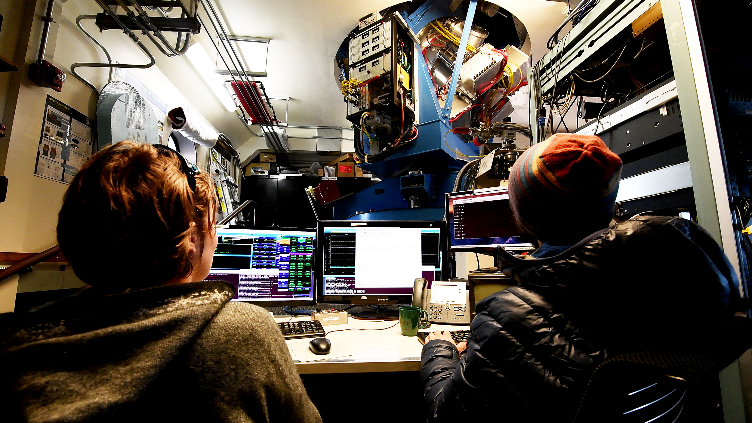 Marion Dierickx and Samuel Harrison operate the BICEP3 Telescope from inside the Dark Sector Laboratory.