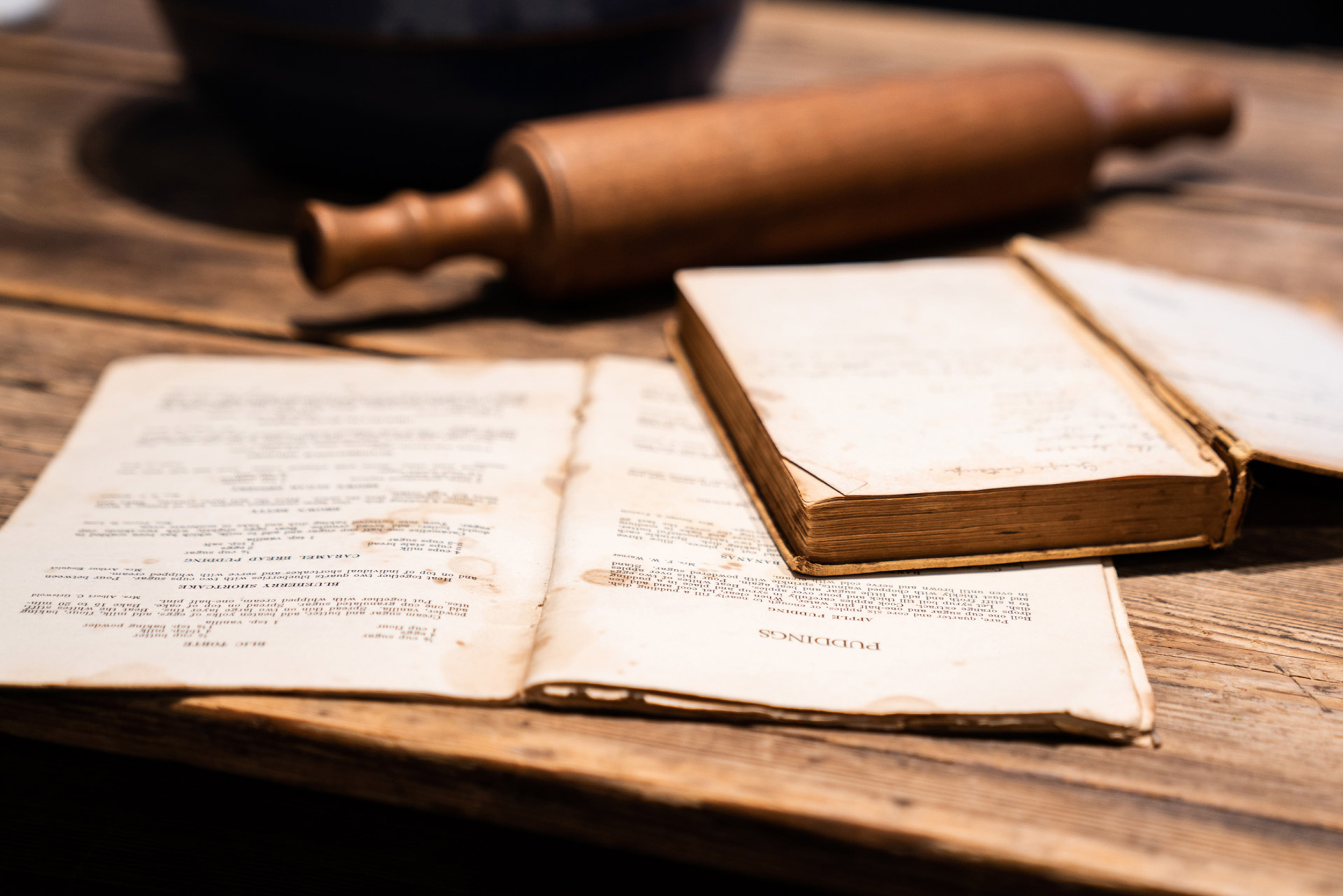 A detail of a cookbook and rolling pin.