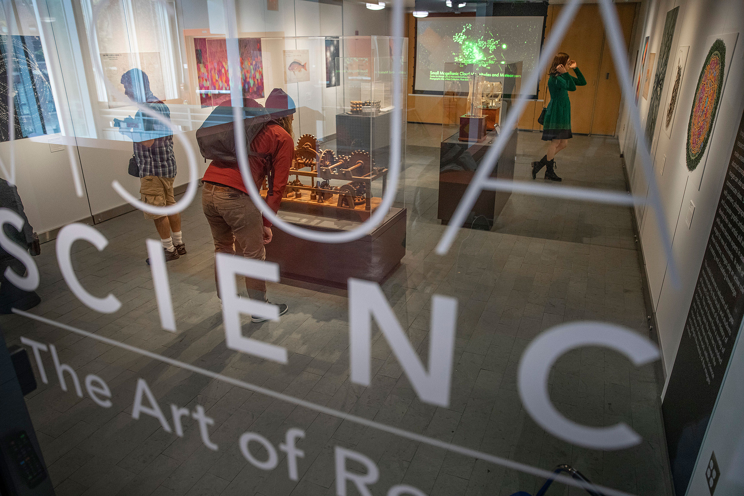 A glass door looking into a museum of Harvard historical instruments.