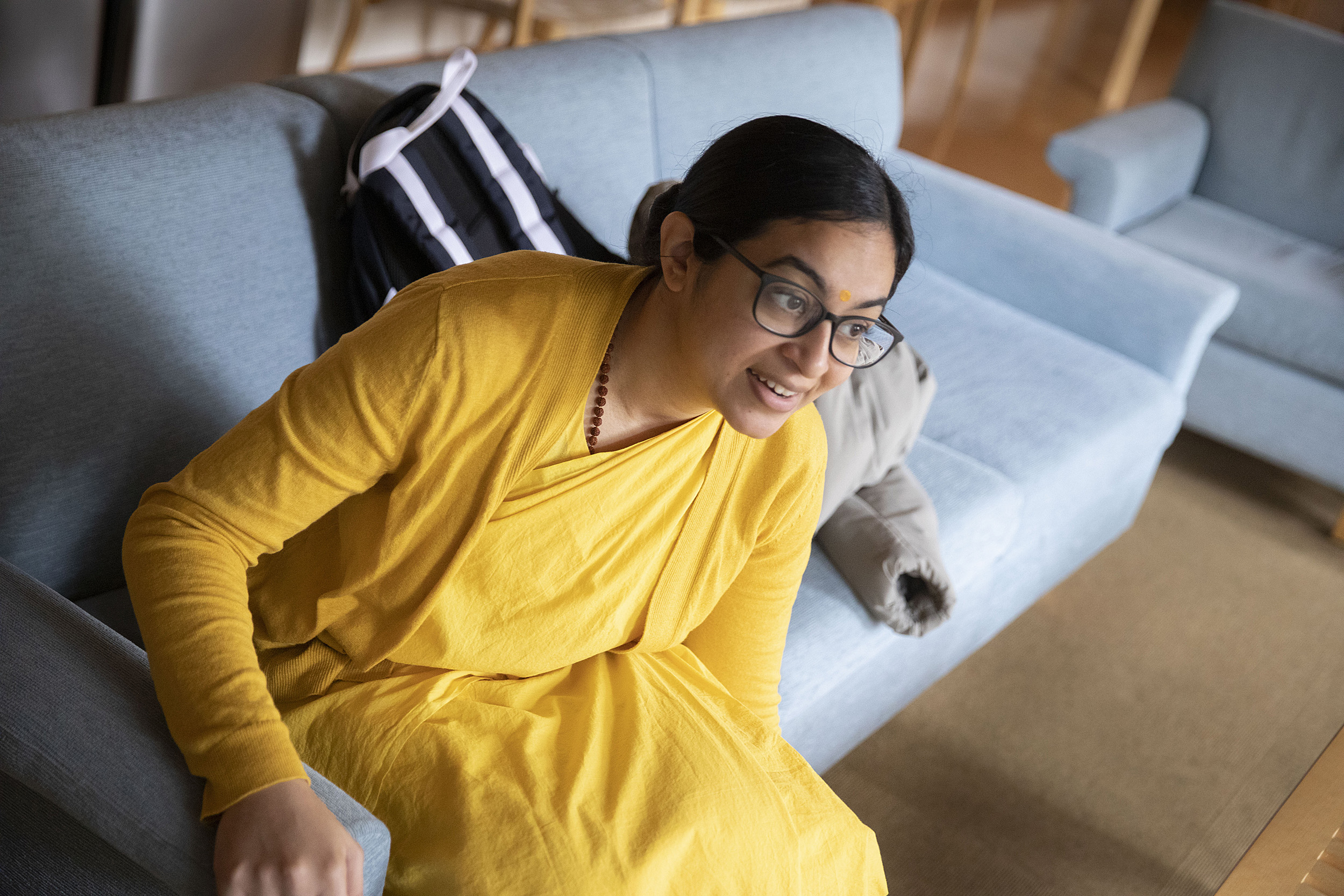 Brahmacharini Shweta Chaitanya sitting on a couch.