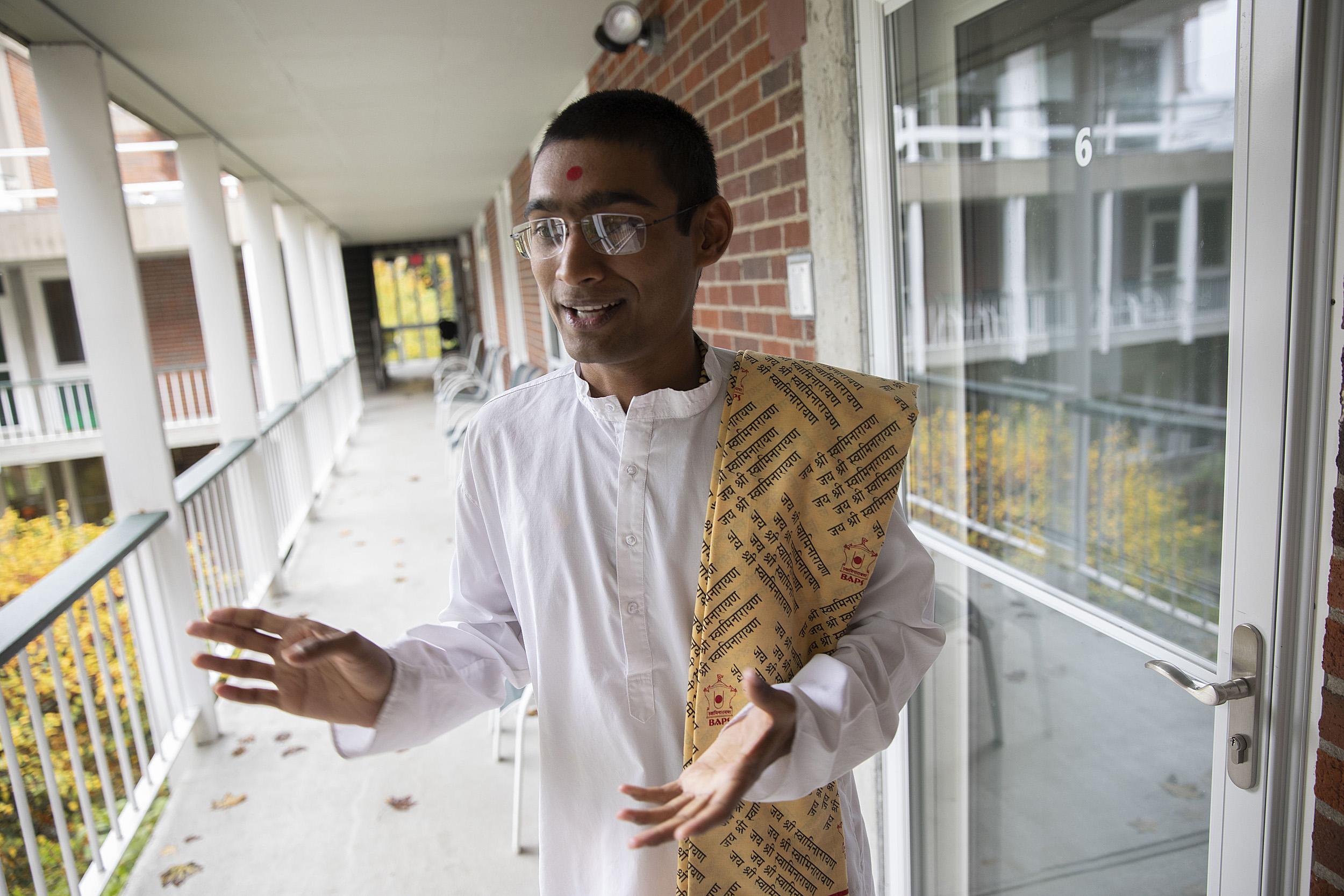 Sadhak Akshar Parsana talking in the walkway at the Divinity School.