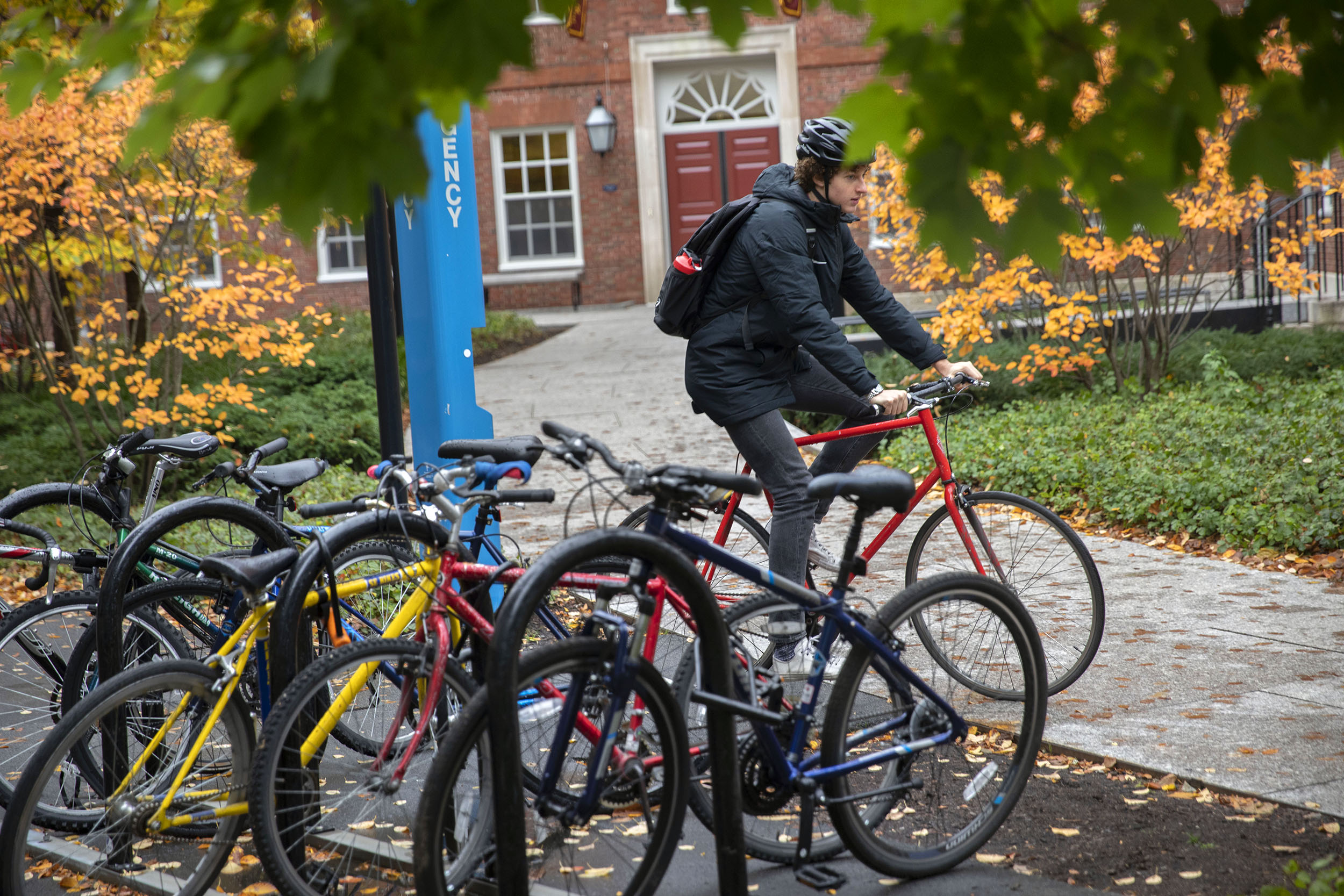 Hugo Milner rides his bike outside Dunster House