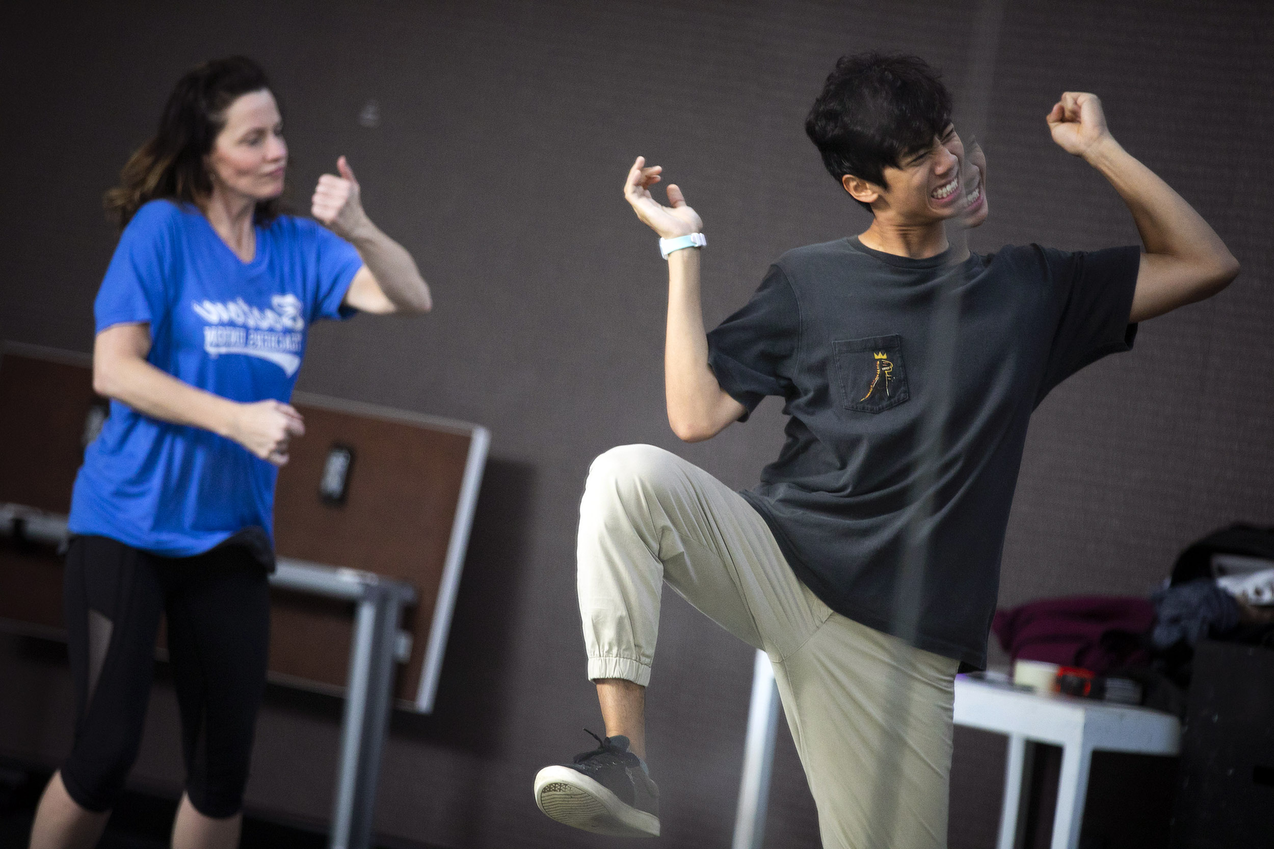 Rene Martin and Noah Ramos are reflected in the mirror while dancing during class.