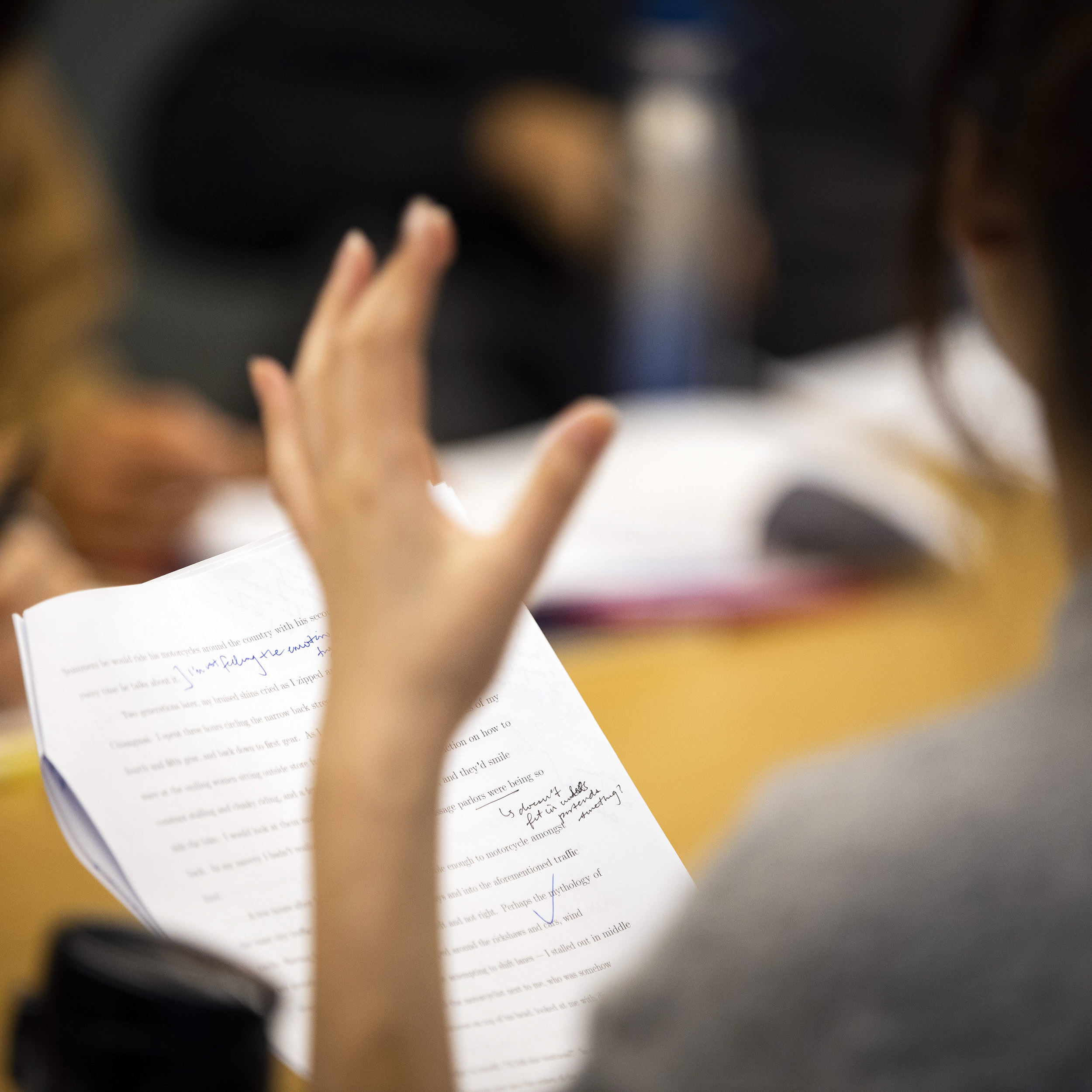 Students gesture during class.