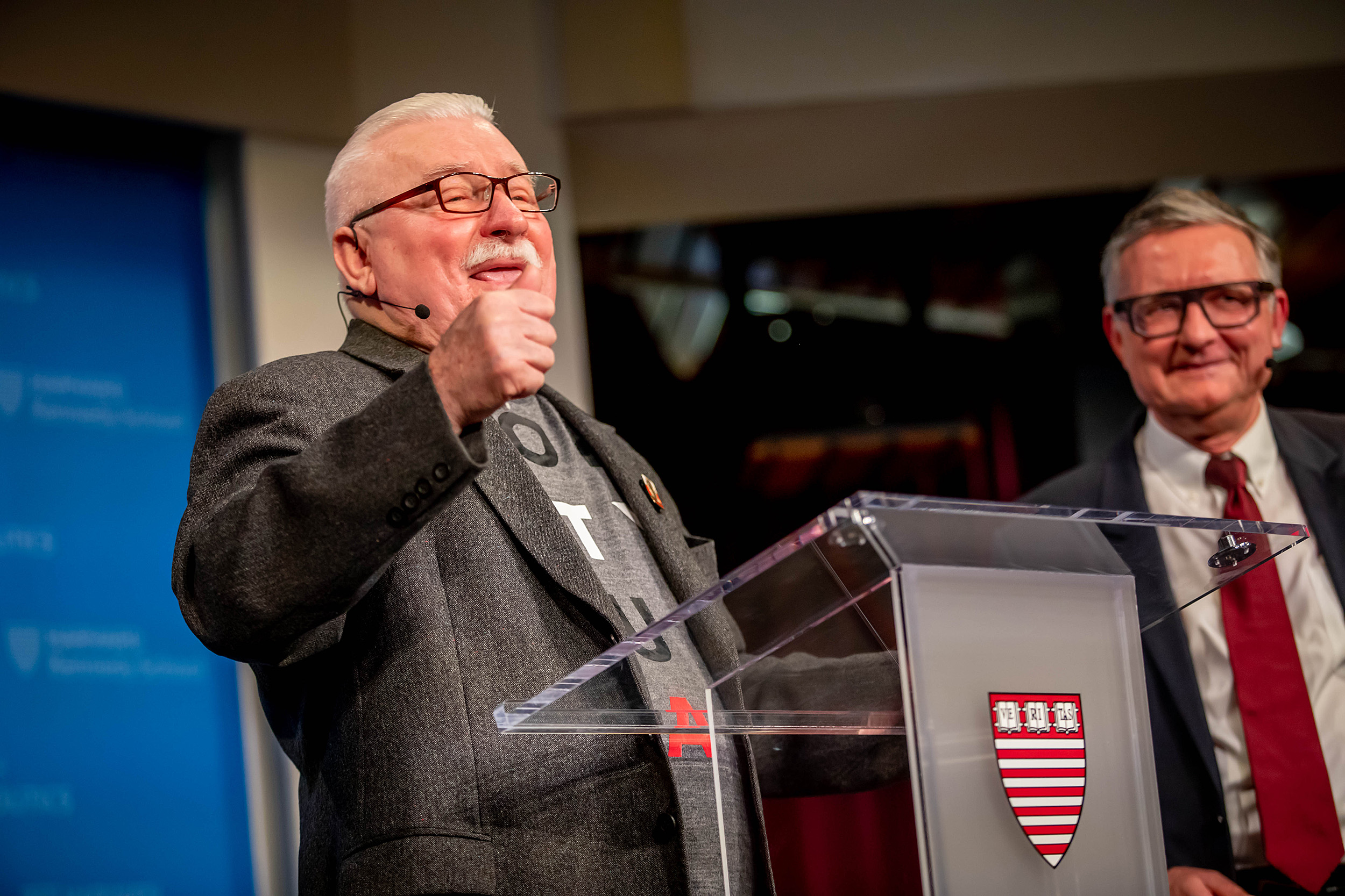 Walesa onstage speaking from podium.