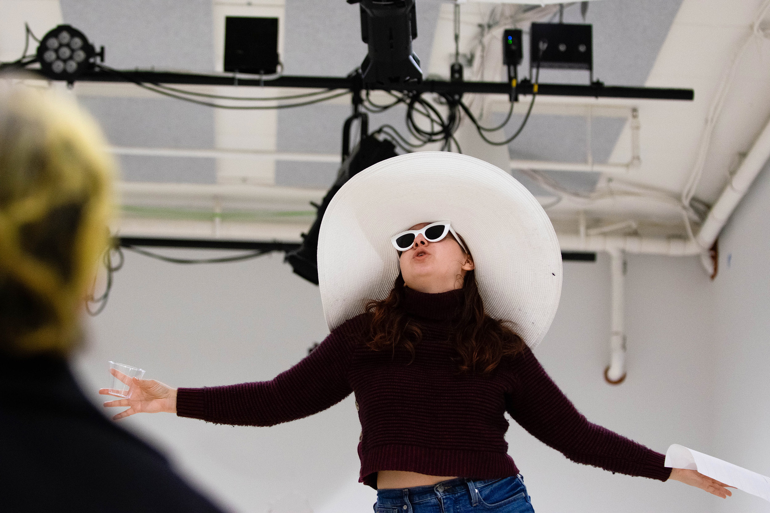 Allie Jeffay raises her hands during rehearsal.