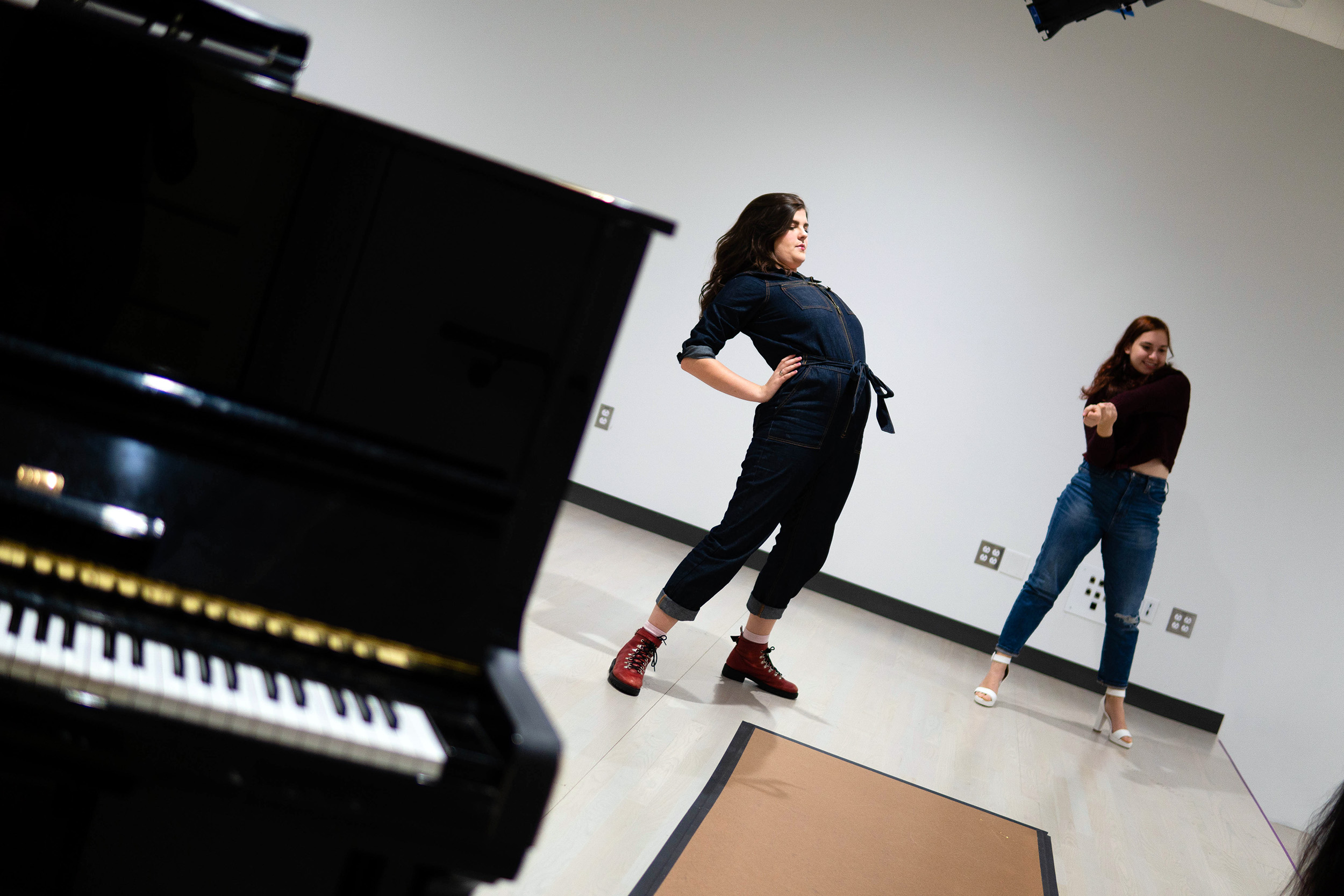 Elle Shaheen and Allie Jeffay stretch before rehearsal.