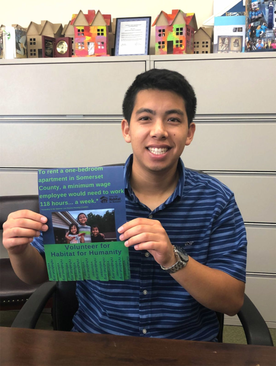 Jason Lam holding one of his signs